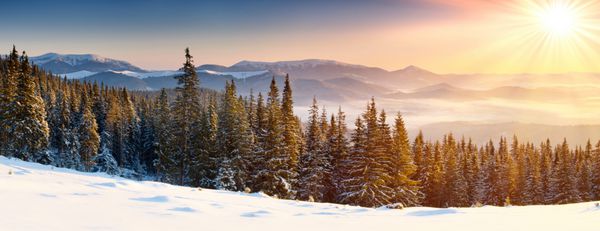 غروب باشکوه خورشید در چشم انداز کوه های زمستانی تصویر HDR