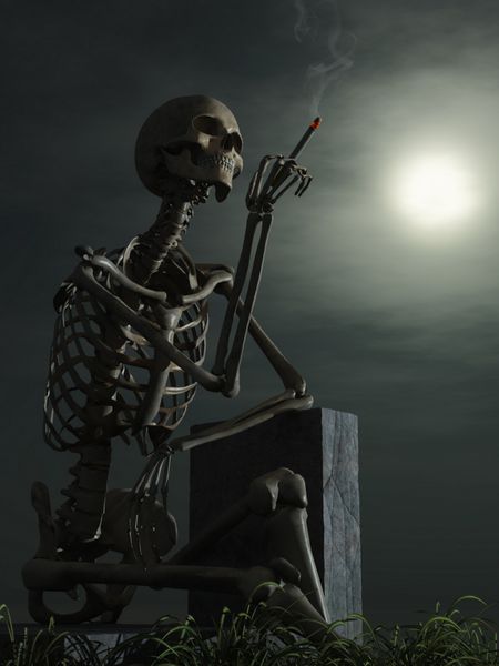 اسکلت سیگاری که روی سنگ قبر قرار گرفته است