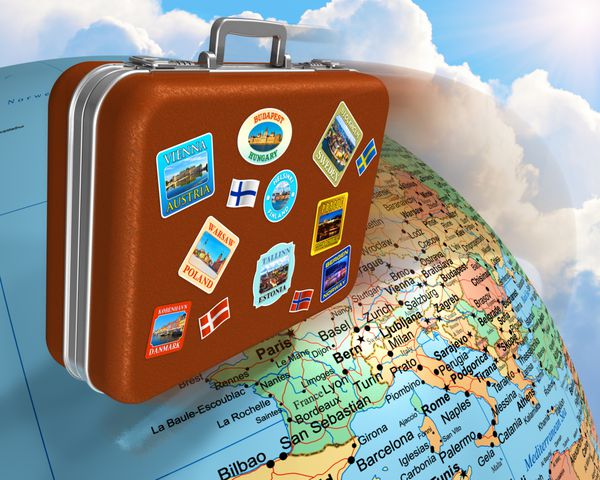 چمدان مسافرتی چرمی با برچسب هایی که در سراسر کره زمین پرواز می کنند
