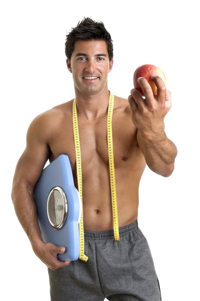 مرد جوان عضلانی با ترازو سیب و وزن