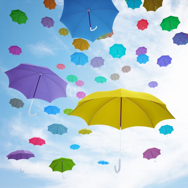 چترهای رنگارنگ مختلف که در بالا در هوا پرواز می کنند