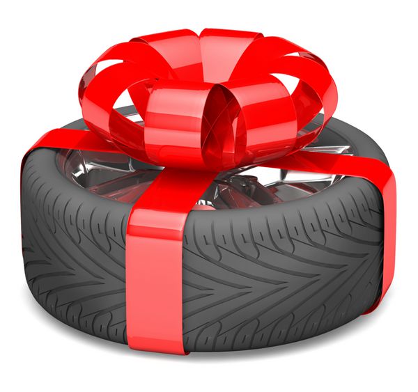 چرخ هدیه با روبان قرمز به عنوان هدیه گره خورده است تصویر روی سفید