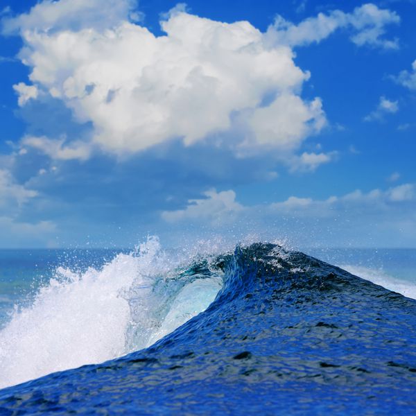 موج اقیانوس آبی سفید خشن در حال سقوط است