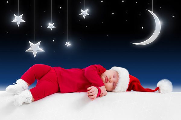 کودک کریسمس در شب افسانه پس زمینه خواب است