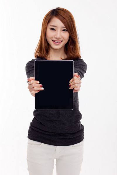 زنی که رایانه لوحی جدا شده در پس زمینه سفید را در دست دارد