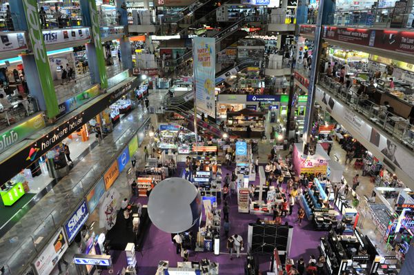 بانکوک - 5 مارس خریداران در 5 مارس 2012 در بانکوک تایلند از Panthip Plaza بزرگترین مرکز خرید فناوری اطلاعات در تایلند بازدید می کنند پانتیپ پلازا به فروش فیلم ها و نرم افزارهای تقلبی معروف است