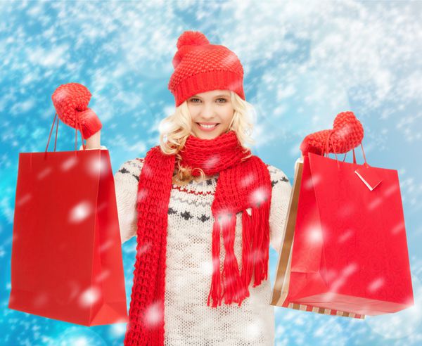 تعطیلات فروش خرید مفهوم کریسمس - دختر نوجوان زیبا در لباس های زمستانی با کیسه های خرید