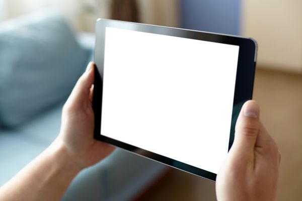 رایانه لوحی دیجیتال با صفحه نمایش جدا شده در دست مردان در پس زمینه خانه یا دفتر