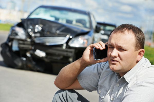 مرد راننده ناراحت بزرگسال در حال بحث با تلفن همراه در مقابل تصادف خودرو تصادف تصادف در جاده شهری