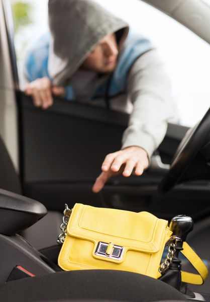 مفهوم حمل و نقل جنایت و مالکیت - دزد کیف را از ماشین می دزدد
