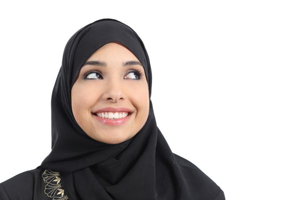 زن زیبای عربی که به تبلیغاتی در بالا جدا شده روی پس‌زمینه سفید نگاه می‌کند