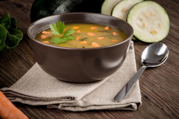 سوپ با سبزیجات روی میز چوبی