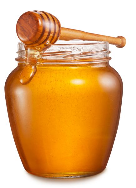 شیشه ای پر از عسل و چوب چوبی روی آن بریدن مسیرها