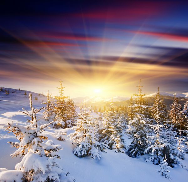 غروب باشکوه خورشید در چشم انداز کوه های زمستانی تصویر hdr