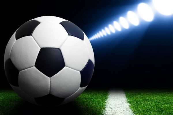 توپ فوتبال در استادیوم سبز عرصه در نورافکن های روشن شبانه