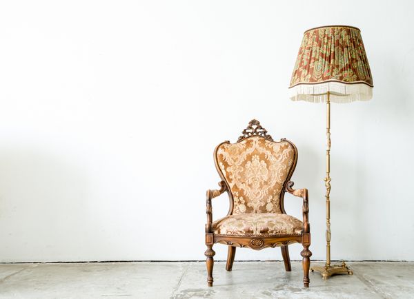 کاناپه مبل صندلی راحتی به سبک کلاسیک در اتاقی قدیمی با چراغ میز