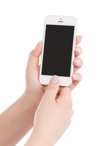 دست های زن که تلفن هوشمند مدرن سفید را در دست گرفته و دکمه را فشار می دهد