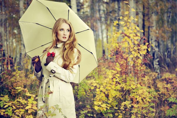 پرتره مد یک زن جوان زیبا در جنگل پاییزی دختر با چتر