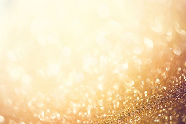 پس زمینه طلای کریسمس پس‌زمینه‌ی پر زرق و برق انتزاعی طلایی و درخشان با ستاره‌های چشمک زن بوکه تار
