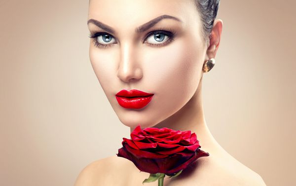 مدل لباس زیبایی زن f پرتره با گل رز قرمز لب های قرمز زن زیبا با آرایش لوکس مفهوم مراقبت از پوست پوست تمیز تازه پس زمینه بژ
