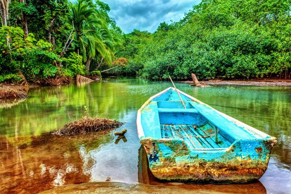 قایق قدیمی در رودخانه گرمسیری pl مناسب برای ماهیگیری ماجراجویی تابستانی عجیب و غریب طبیعت شگفت انگیز پارک ملی کاستاریکا آمریکای مرکزی