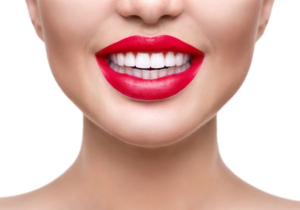 سفید کردن دندان لبخند سفید سالم از نزدیک زن زیبایی با لبخند کامل - لب و دندان دختر مدل زیبا با لب های قرمز جدا شده در پس زمینه سفید پوست کامل