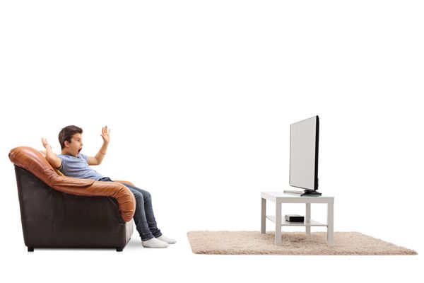 بچه ترسو تماشای تلویزیون نشسته در صندلی جدا شده بر روی زمینه سفید