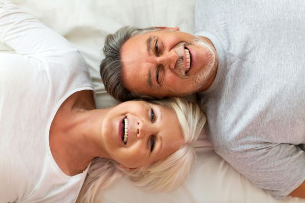 Senior couple lying in bed together
