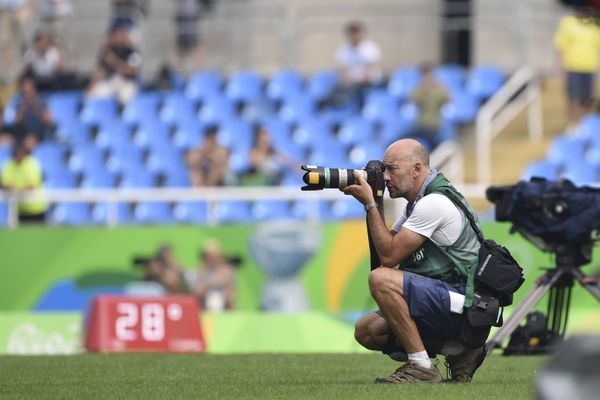 Rio de Janeiro Brazil august 16 2016 Runner Photographer working during 5000m women