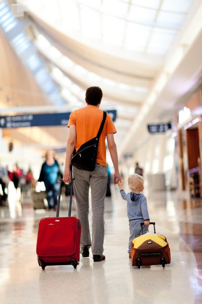 پدر و پسر با چمدان در فرودگاه