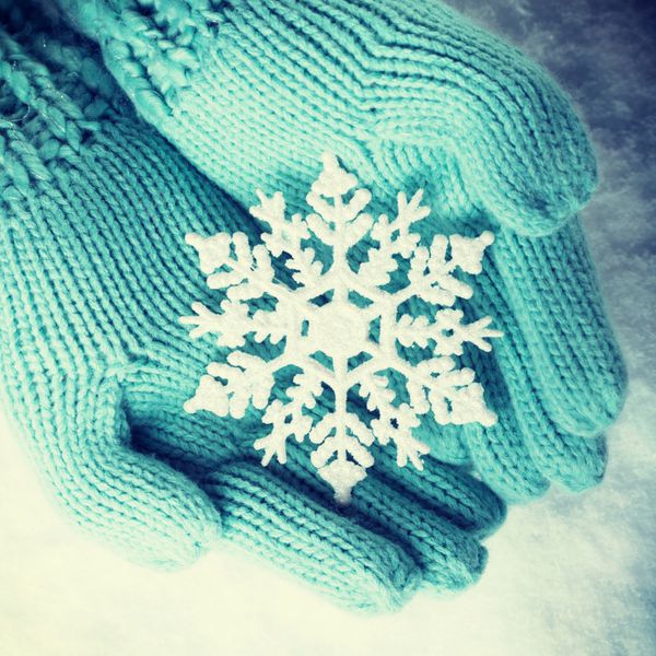 دستکش دست زنانه در دستمال مرطوب دست و پنجه نرم با یک دست کت و شلوار کت و شلوار با یک برف پوشیده زیبا در پس زمینه برف عشق و مفهوم سنت فیلتر نمایش مشخصات عمومی
