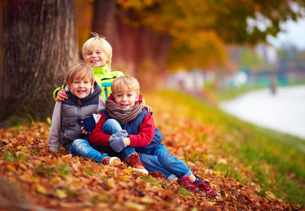 سه بچه خوش تیپ دوستان با هم در پارک پاییز