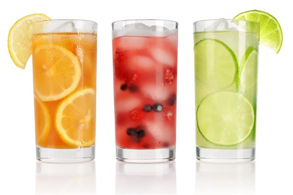نوشیدنی های تابستانی با یخ انواع توت های تازه لیمو و آهک که روی سفید جدا شده اند