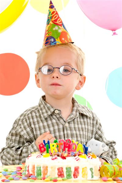 پسر جوانی با عینک با کیک تولد عکس می گیرد