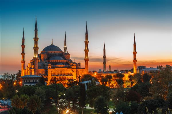 مسجد آبی در استانبول با نور فانوس در پس زمینه آسمان آبی هنگام غروب آفتاب