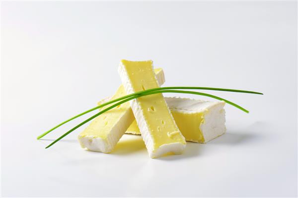 برش های پنیر رسیده سطح صاف تزئین شده با پیازچه