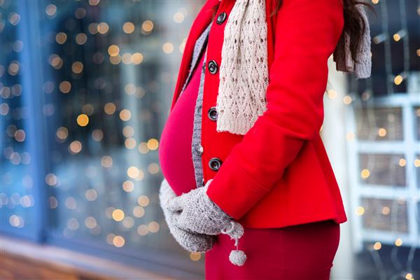 جزئیات شکم زن باردار غیر قابل تشخیص در زمستان در خارج از مغازه ها