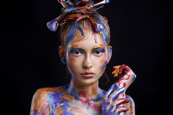 پرتره دختر جوان با آرایش خلاقانه چند رنگ روی مشکی