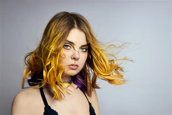 زن با موهای زرد خلاقانه و آرایش با بدلیجات رشته های بنفش مو لایه دوم
