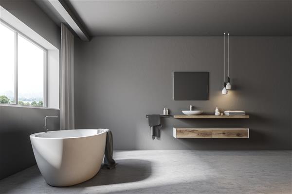 فضای داخلی یک حمام خاکستری با کف بتنی یک پنجره بزرگ با پرده های خاکستری یک وان سفید و یک سینک رندر سه بعدی