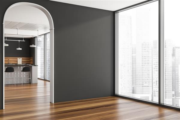 گوشه ای از فضای داخلی خاکستری با یک طاق نما یک پنجره از کف تا سقف یک دیوار خالی و یک اتاق آشپزخانه شیک در پس زمینه مفهومی از طراحی آپارتمان مدرن رندر سه بعدی
