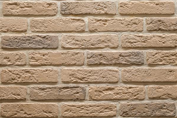 دیوار آجری بژ بافت بافت سنگ کاشی های تزئینی برای تزئین دیوار پس زمینه آجر تزئینی بژ سبک دکور زیر شیروانی سطح ساختاری تقلید از آجر قدیمی است