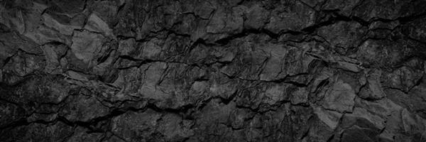 بافت سنگ حجمی با ترک پس زمینه سنگ سیاه با فضای کپی برای طراحی بنر عریض