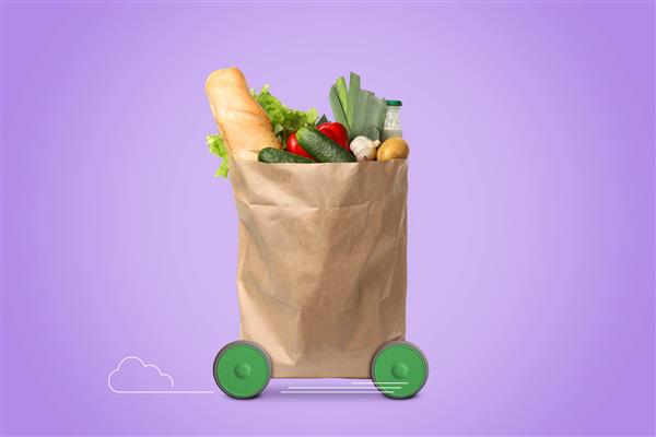 کیسه خرید کاغذی پر از محصولات روی چرخ در پس زمینه بنفش سفارش با عجله به مشتری خدمات تحویل غذا