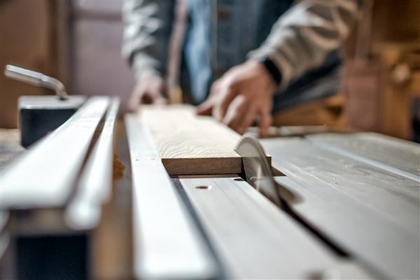 مرد قفقازی ساخت قطعات چوبی برای مبلمان سفارشی بر روی ماشین ابزار به نام رنده ضخامت در نجاری تولید مفهوم چوب