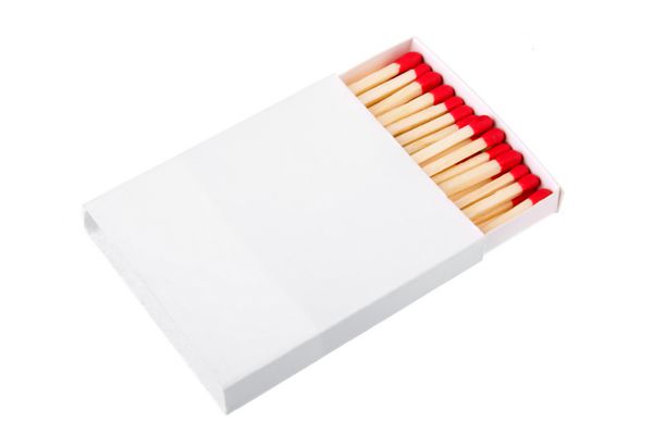 کبریت قرمز در یک جعبه سفید جدا شده روی پس زمینه سفید