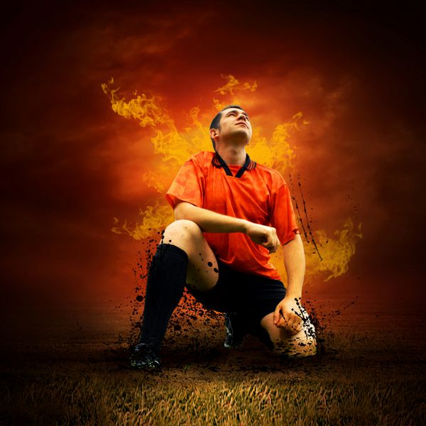 بازیکن فوتبال در زمین بیرون از خانه شعله آتش می زند