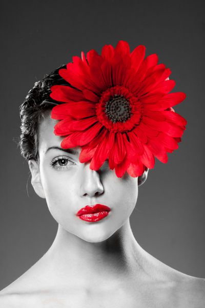 پرتره سیاه و سفید زنی با لب های قرمز و گل قرمز روی صورتش