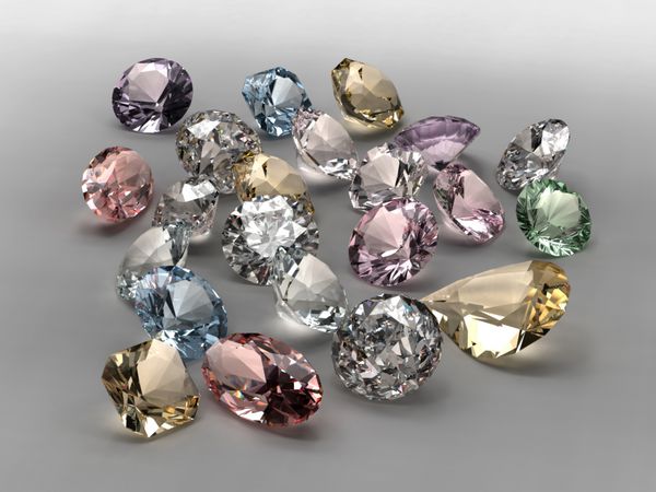 الماس های براق در اشکال و رنگ های مختلف در زمینه خاکستری