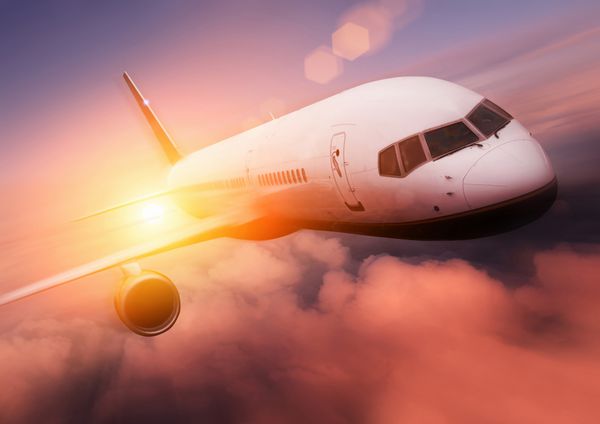 سفر با هواپیما غروب هواپیمای مسافربری در برابر غروب خورشید